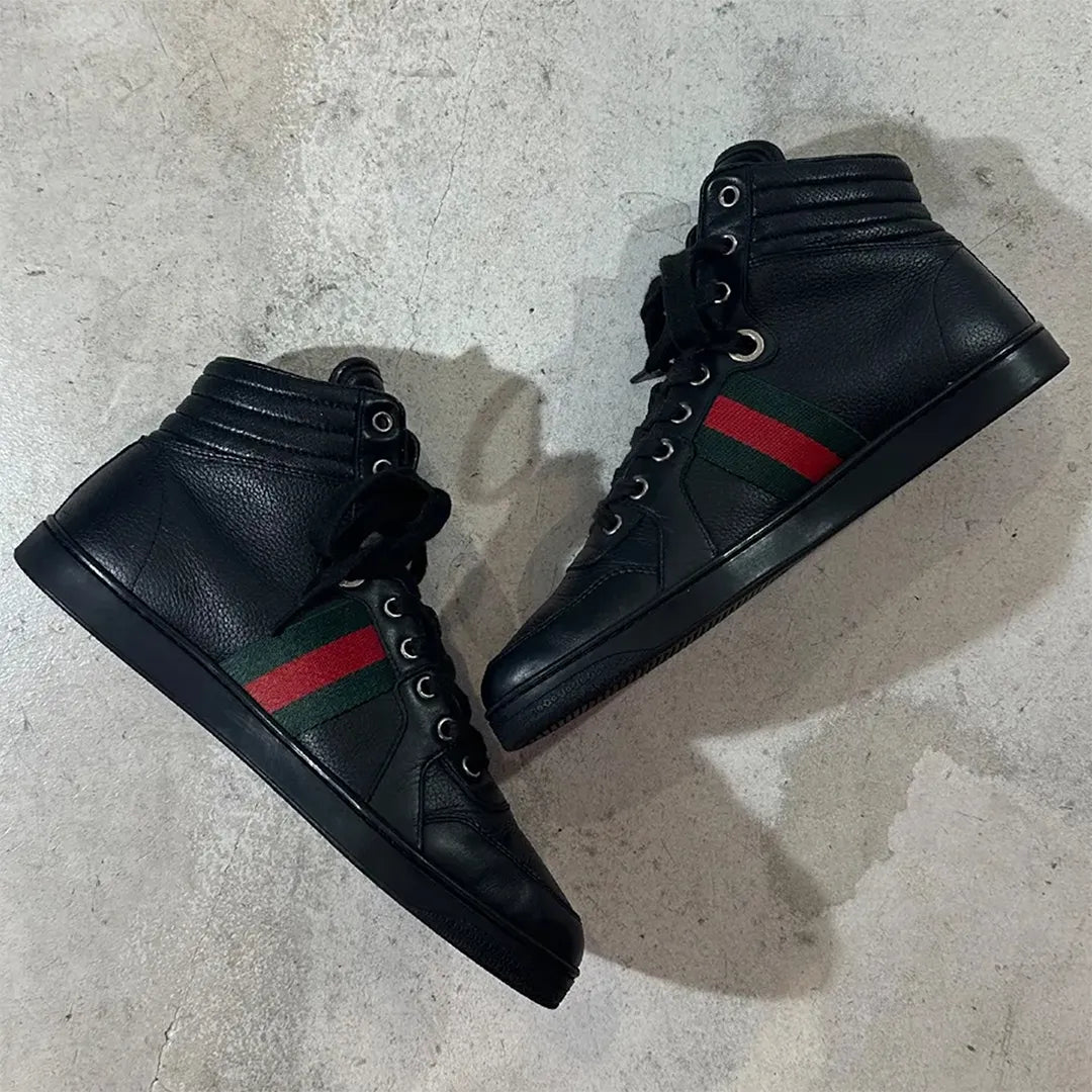 GUCCI 2010年代アーカイブの黒レザーハイカットスニーカー。サイドに赤と緑のウェブストライプ（シェリーライン）を配したミニマルなデザイン。